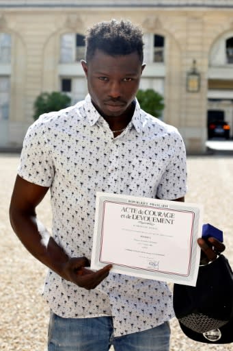 Mamoudou Gassama received a certificate of courage and dedication signed by Paris Police Prefect Michel Delpuech