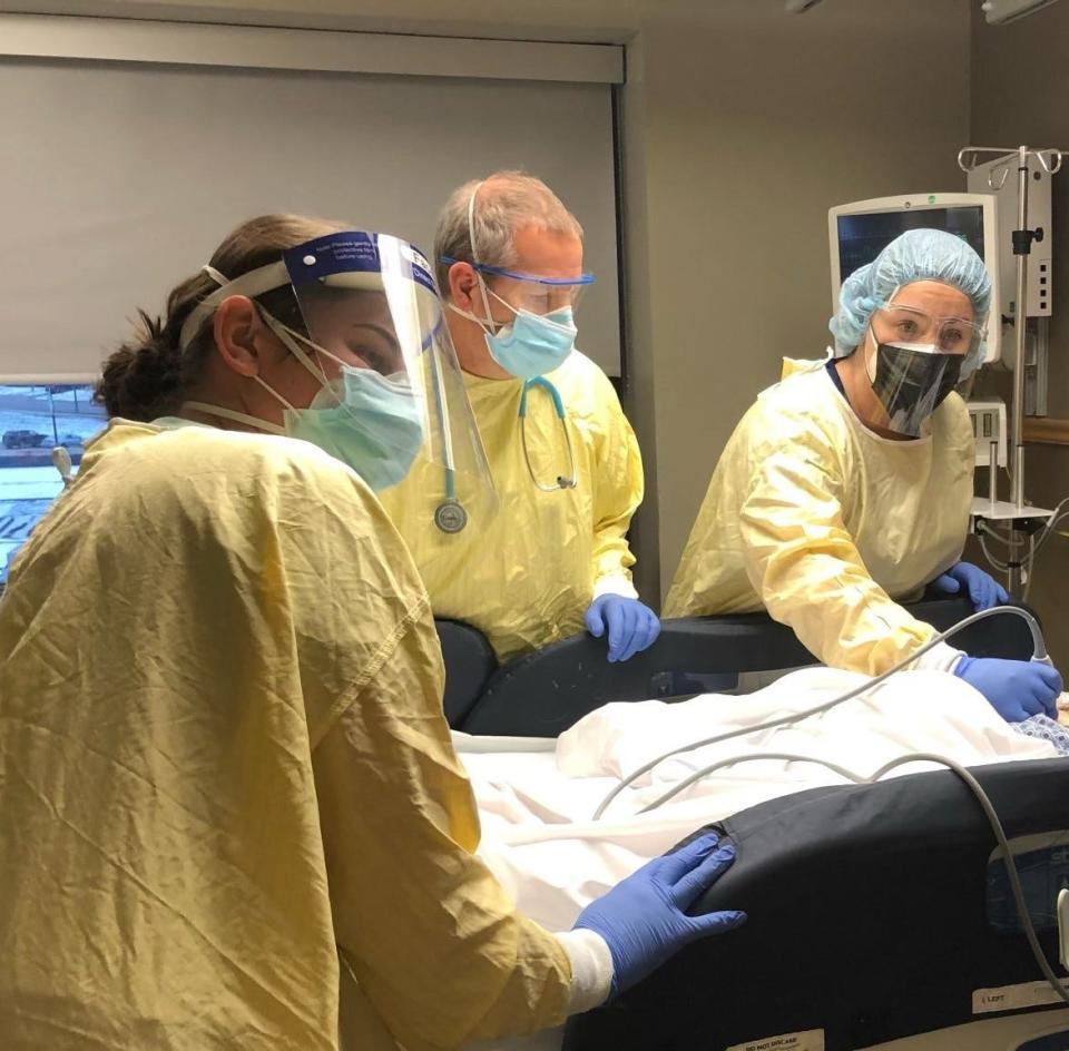 A medical team cares for a patient in the COVID-19 Unit at Bronson Battle Creek on Thursday, Dec. 9, 2021.