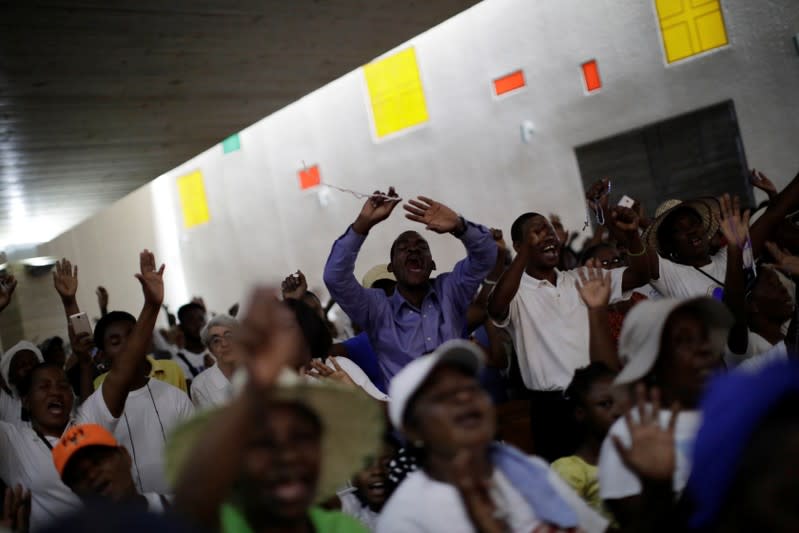 Faithful pray at Christ Roi church before a march organised by religious leaders in Port-au-Prince