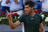 Carlos Alcaraz, of Spain, celebrates after winning the final match against Alexander Zverev, of Germany, at the Mutua Madrid Open tennis tournament in Madrid, Spain, Sunday, May 8, 2022. (AP Photo/Paul White)