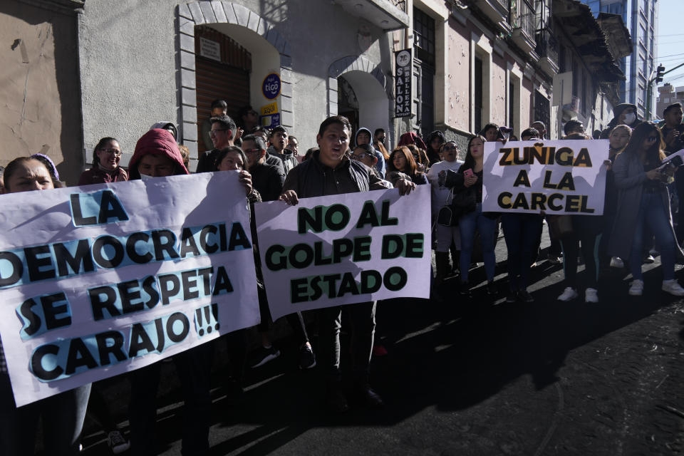 Supporters of President Luis Arce hold banners with messages reading in Spanish from left; "Democracy should be respected, No to the coup, Zuniga to jail," during a demonstration in La Paz, Bolivia, Friday, June 28, 2024, two days after Army troops stormed the government palace in what President Luis Arce called a coup attempt. (AP Photo/Juan Karita)