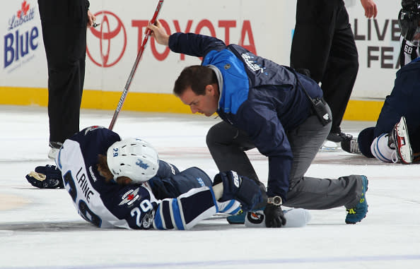 BUFFALO, NY - JANUARY 07: Patrik Laine #29 of the Winnipeg Jets is tended to be a trainer after a third period check by the Buffalo Sabres during an NHL game at the KeyBank Center on January 7, 2017 in Buffalo, New York. (Photo by Bill Wippert/NHLI via Getty Images)