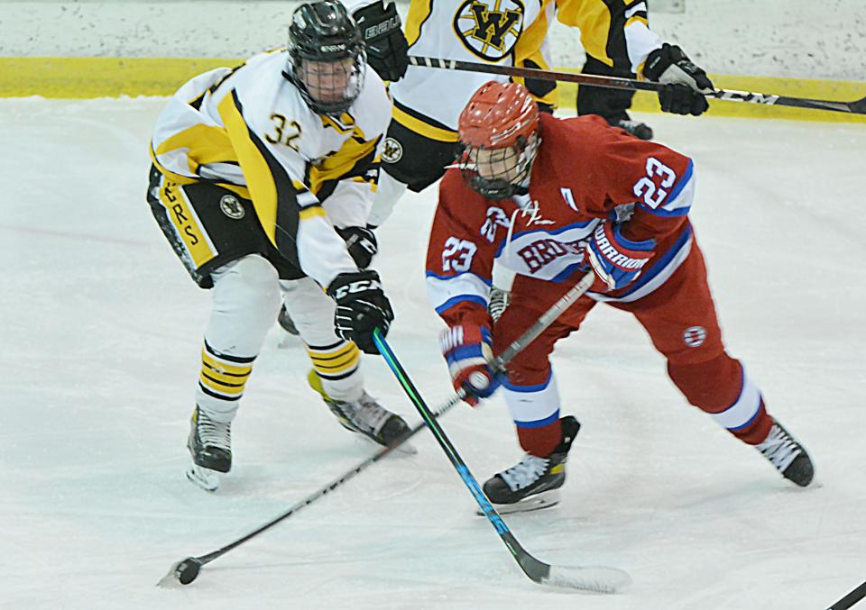 Ethan Skott of the Watertown Lakers (32) pressures Jack Merritt of the Brookings Rangers during their South Dakota Amateur Hockey Association game on Friday, Dec. 2, 2022 in the Maas Ice Arena.