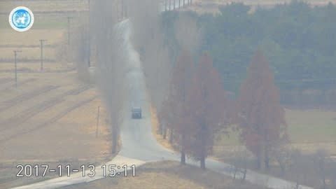 A vehicle carries a defecting North Korean soldier races along a road in the Demilitarized Zone between North and South Korea - Credit: Reuters