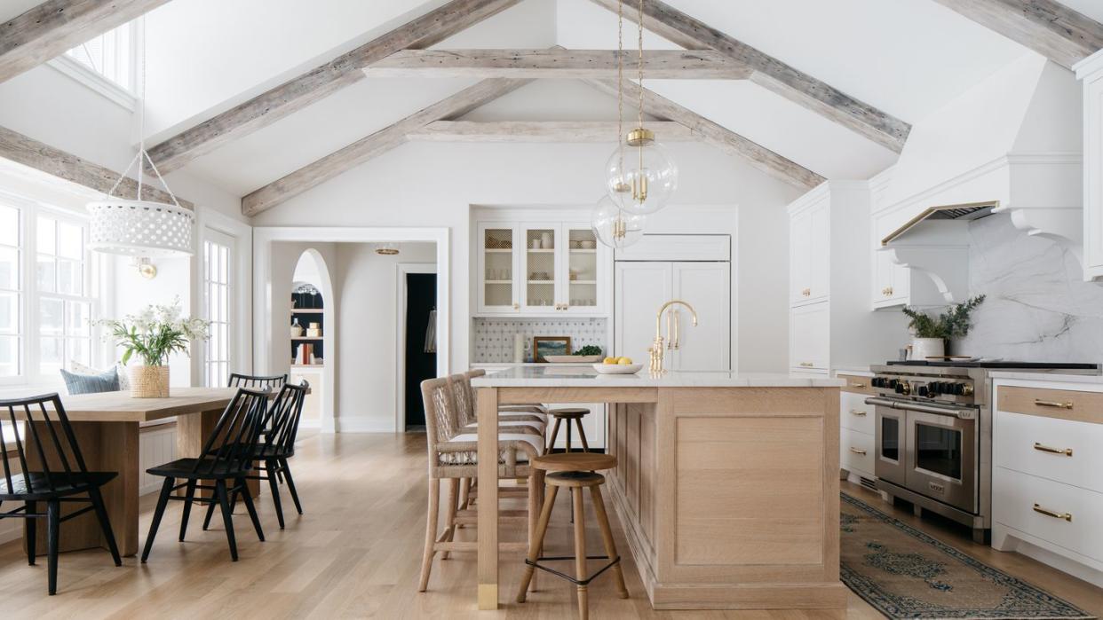 a kitchen with a chandelier and a table