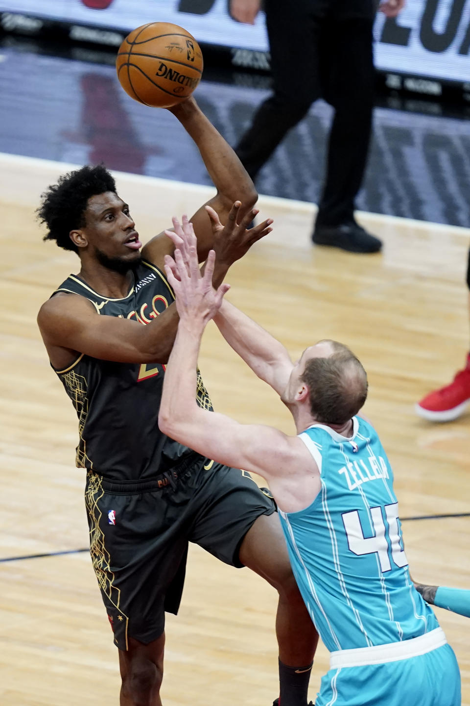 Chicago Bulls' Thaddeus Young, left, shoots over Charlotte Hornets' Cody Zeller during the first half of an NBA basketball game Thursday, April 22, 2021, in Chicago. (AP Photo/Charles Rex Arbogast)