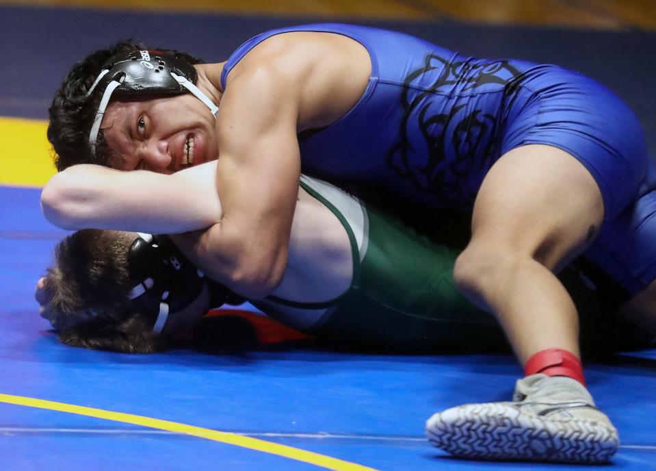 North Mason's Pedro Salvador, top, puts a hold on Port Angeles's Ethan Abrams during their 145-pound bout for the Olympic League 2A sub-regional championships at Bremerton High School on Saturday, Feb. 4, 2023.