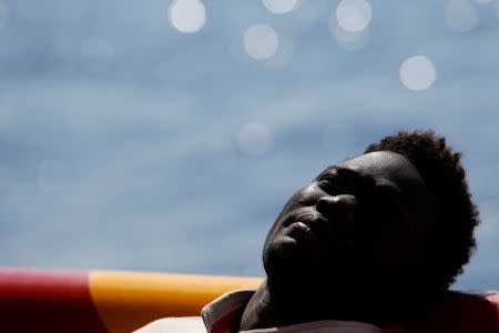 A migrant rests on the deck of the Migrant Offshore Aid Station (MOAS) ship Topaz Responder after being rescued around 20 nautical miles off the coast of Libya, June 23, 2016. REUTERS/Darrin Zammit Lupi SEARCH "RESCUE MOAS" FOR THIS STORY. SEARCH "THE WIDER IMAGE" FOR ALL STORIES. MALTA OUT. NO COMMERCIAL OR EDITORIAL SALES IN MALTA