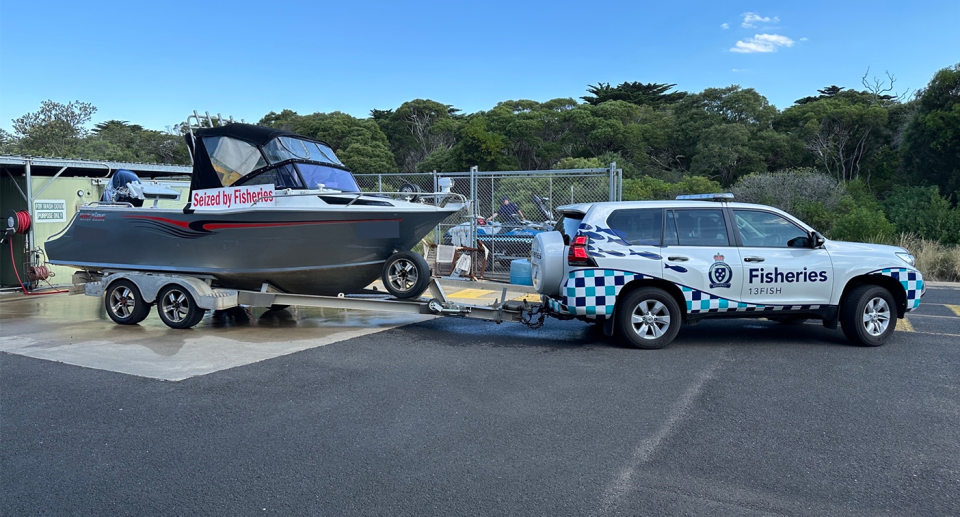 A Fisheries boat towing the seized aluminium boat.