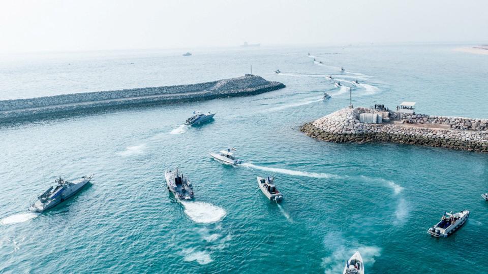 Islamic Revolutionary Guard Corps (IRGC) Navy's speedboats move in bright blue water in an aerial photo
