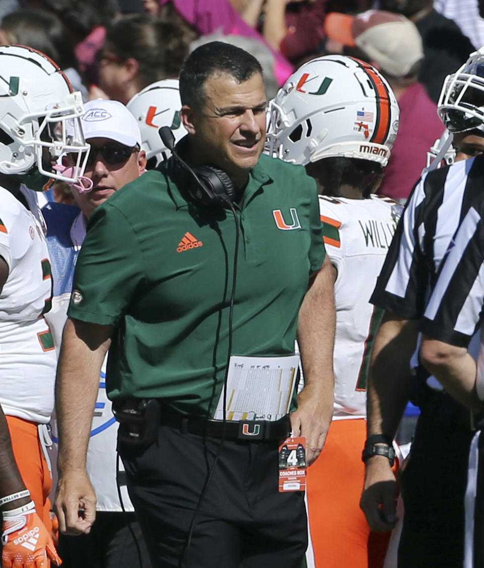 Miami head coach Mario Cristobal walks the sideline during the first half of an NCAA football game against Virginia Tech, Saturday Oct. 15 2022, in Blacksburg Va. (Matt Gentry/The Roanoke Times via AP)