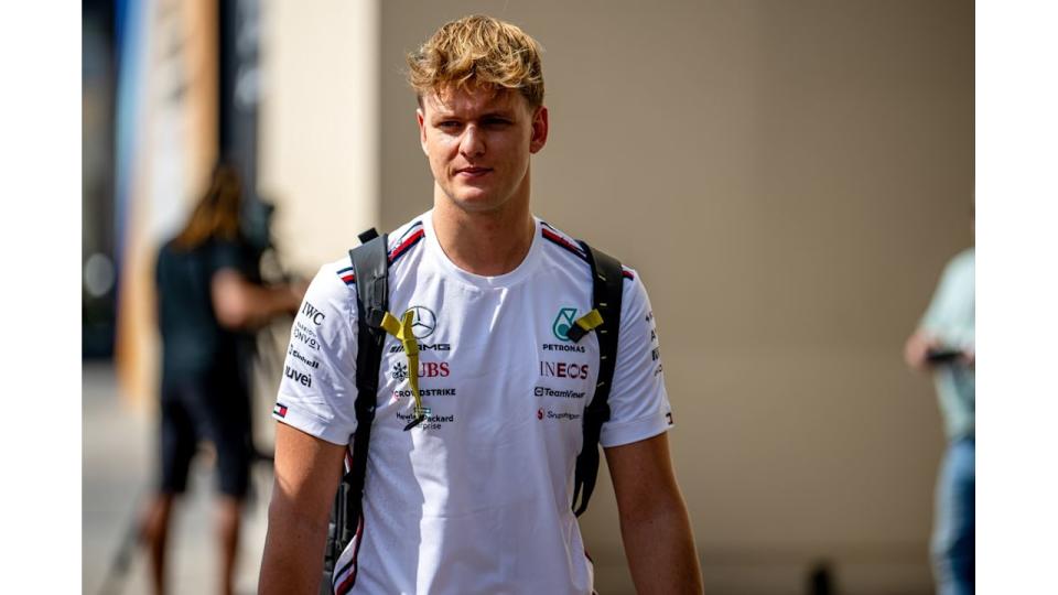 Mick Schumacher walking a white shirt