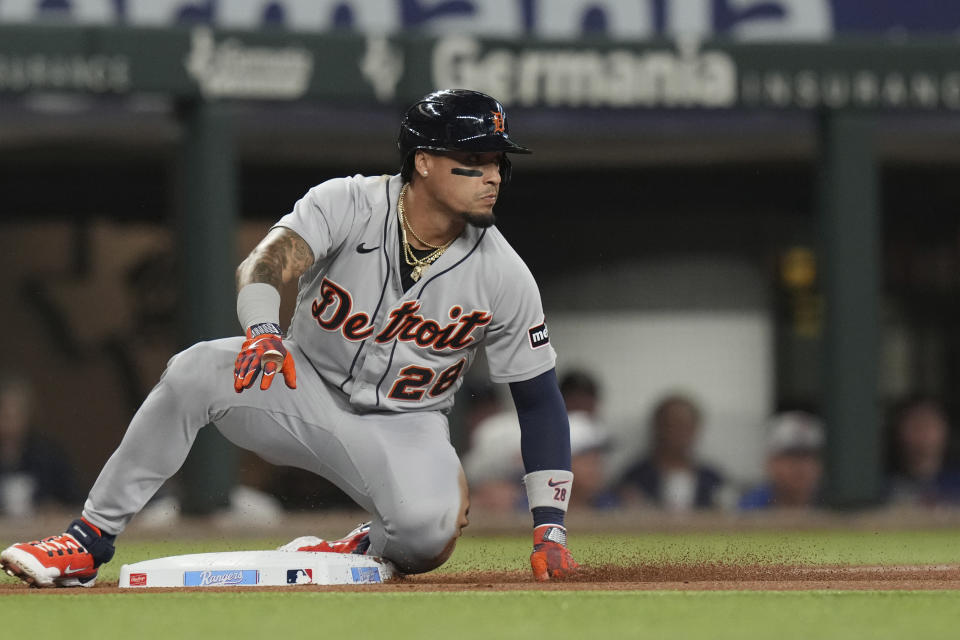 Detroit Tigers' Javier Baez slides safely into third base advancing on single by teammate Jonathan Schoop during the second inning of a baseball game against the Texas Rangers in Arlington, Texas, Tuesday, June 27, 2023. (AP Photo/LM Otero)