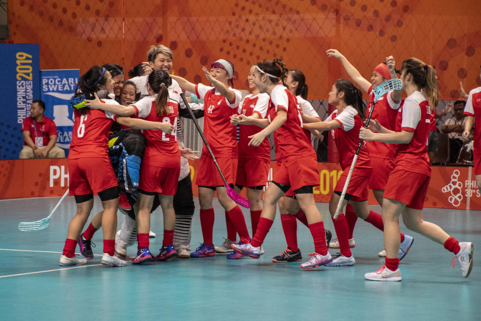 The Singapore women's floorball team celebrate their 3-2 win over Thailand in the final, as they clinch the gold medal. (PHOTO: Alfie Lee/Sport Singapore)