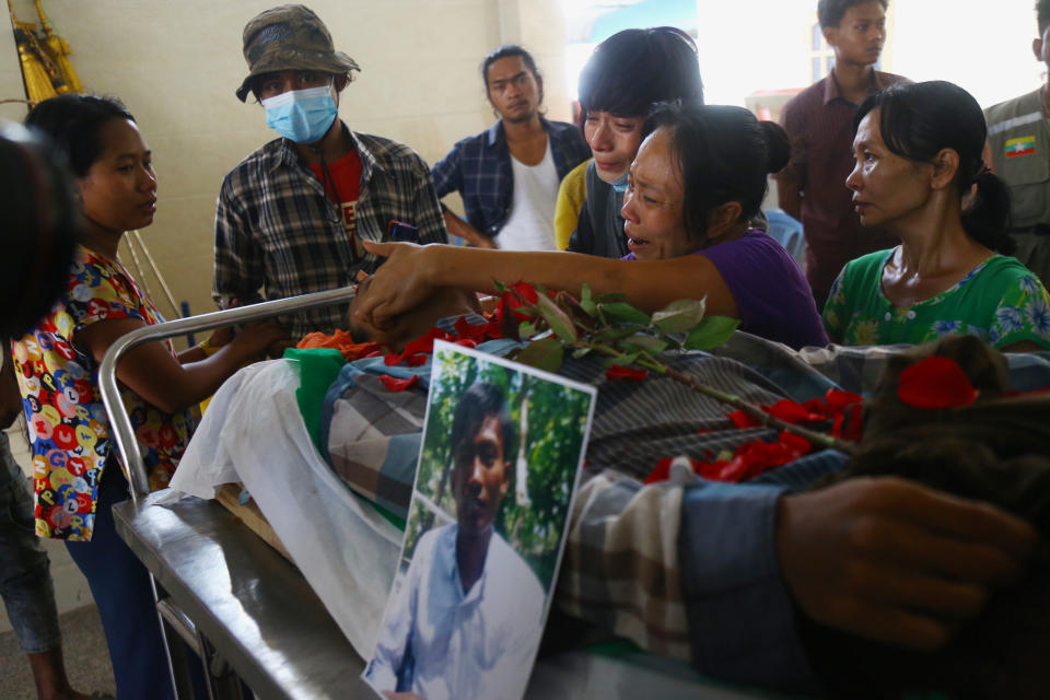 Family members mourn over the death of Aung Myo Thant during his funeral in Yangon, Myanmar, Tuesday, March 30, 2021. Aung Myo Thant was killed Monday during a clash with security forces at a protest against the military's coup that ousted the government of Aung San Suu Kyi. (AP Photo)