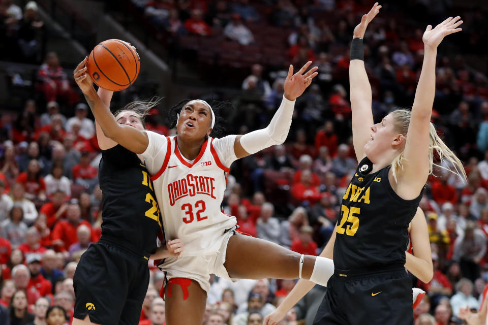 Iowa guard Caitlin Clark, left, Ohio State forward Cotie McMahon, center, and Iowa forward Monika Czinano fight for a rebound during the second half of an NCAA college basketball game at Value City Arena in Columbus, Ohio, Monday, Jan. 23, 2023. (AP Photo/Joe Maiorana)