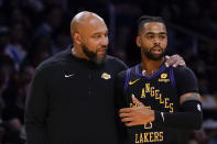 Los Angeles Lakers coach Darvin Ham, left, speaks with guard D'Angelo Russell during the first half of the team's NBA basketball In-Season Tournament game against the Utah Jazz, Tuesday, Nov. 21, 2023, in Los Angeles. (AP Photo/Ryan Sun)