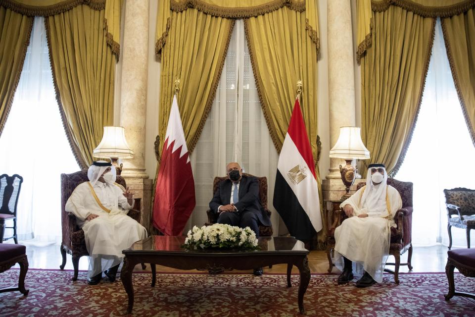 Qatar's Deputy Prime Minister and Foreign Minister Sheikh Mohammed bin Abdulrahman bin Jassim Al-Thani, left, meets with Egyptian Foreign Minister Sameh Shoukry, center, at the Tahrir Palace in Cairo, Egypt, Tuesday, May 25, 2021. (AP Photo/Nariman El-Mofty)