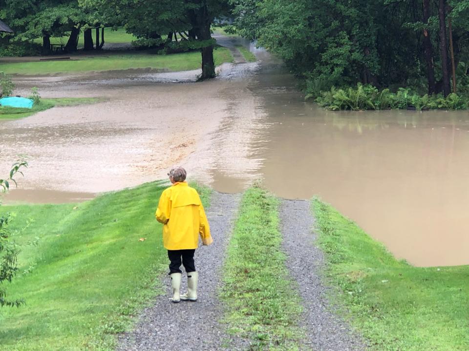 Sally Gardner watches as Naples Creek floodwaters rush into her East Avenue backyard. Tropical Storm Debby brought heavy rain to parts of New York on Friday, Aug. 9, 2024.