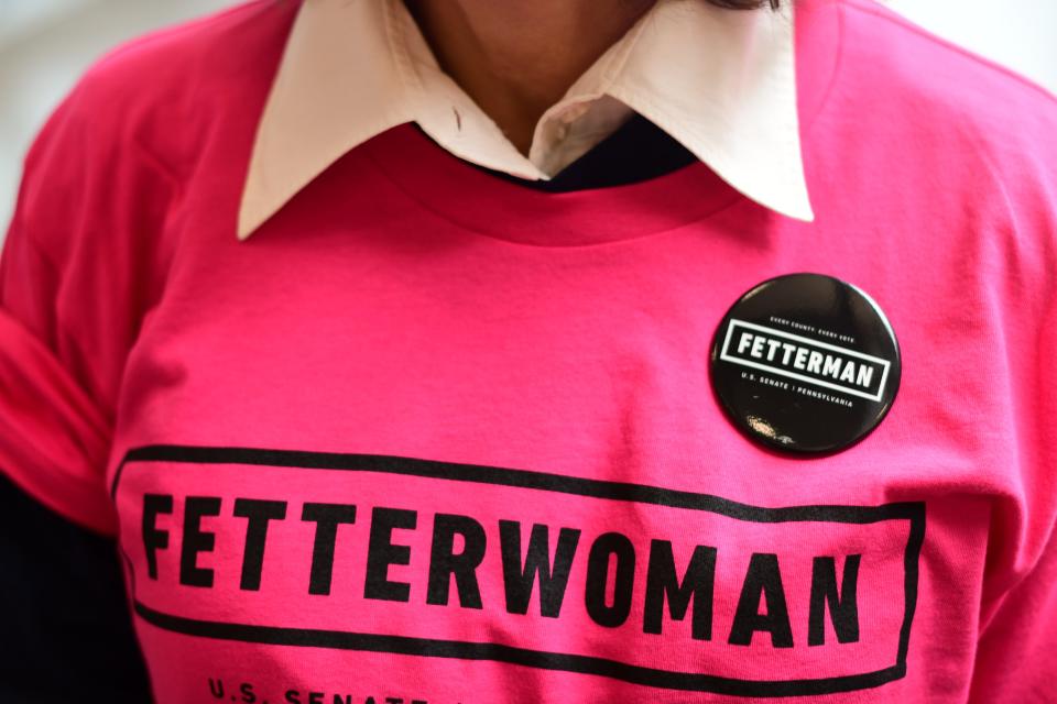 A supporter wears a t-shirt that reads "FETTERWOMAN" and a campaign pin before Democratic Pennsylvania Senate nominee John Fetterman holds a rally with U.S. Congresswomen Madeleine Dean and Mary Gay Scanlon on September 11, 2022 in Blue Bell, Pennsylvania. Fetterman faces GOP U.S. Senate candidate Dr. Mehmet Oz in the November general election.
