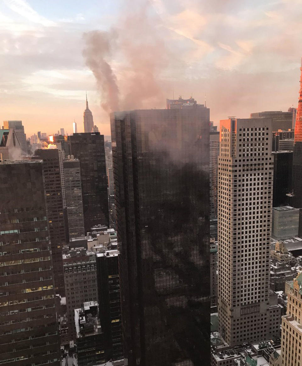 Smoke rises from Trump Tower in New York, Monday afternoon in the aftermath of the rooftop fire. (PA)