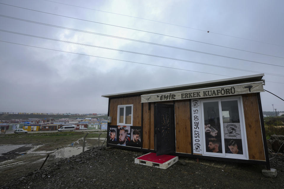 This Friday, Jan. 12, 2024 photo shows a container that has recently been turned into a barber shop by its owner whose business was destroyed in the powerful earthquake that hit on Feb. 6, 2023 in Antakya, southern Turkey. A year after the devastating earthquake, many in the region are struggling to rebuild livelihoods. (AP Photo/Khalil Hamra)