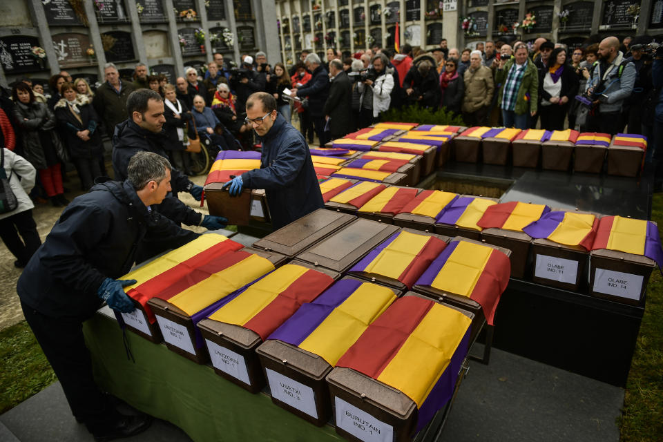 People carry the coffins of some of the 46 coffins of unidentified people killed during the Spanish Civil War, at San Jose cemetery, Pamplona, northern Spain, Monday, April 1, 2019. Marking eight decades since the end of the Spanish Civil War, the remains of 46 unidentified victims of the conflict have been reburied in the northern city of Pamplona. More than half a million people died in the 1936-1939 war between rebel nationalist forces led by Gen. Francisco Franco and defenders of the short-lived Spanish republic. (AP Photo/Alvaro Barrientos)