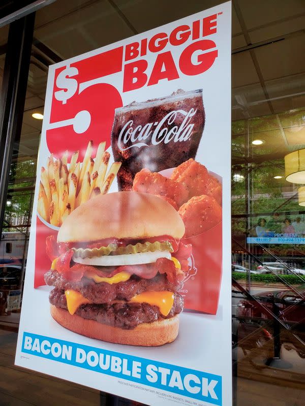 Signs advertising menu items are seen at fast food restaurants in New York City