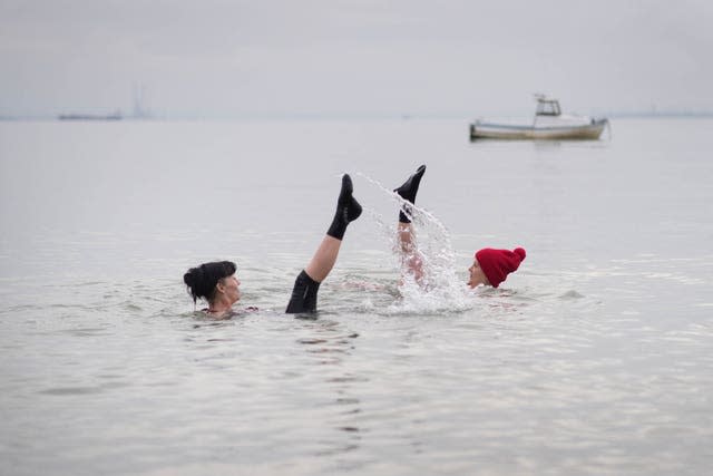 Heavy snow and freezing rain failed to stop these two from taking a dip