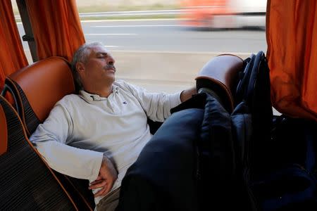 Christian Syrian refugee Kabi Dahdal, rests in a bus which transports fifteen members of the same family who arrived at the Charles-de-Gaulle International Airport in Roissy, October 2, 2015. REUTERS/Stephane Mahe