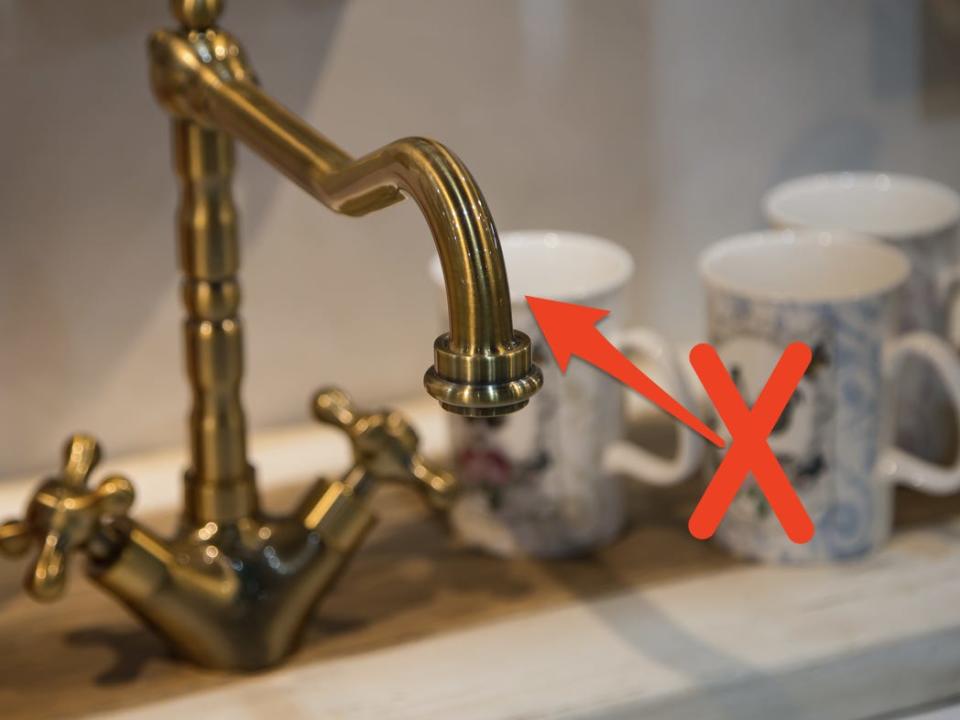 Red X pointing to brass faucet