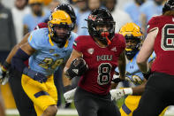 Northern Illinois running back Jay Ducker (8) rushes during the first half of an NCAA college football game against Kent State, Saturday, Dec. 4, 2021, in Detroit. (AP Photo/Carlos Osorio)