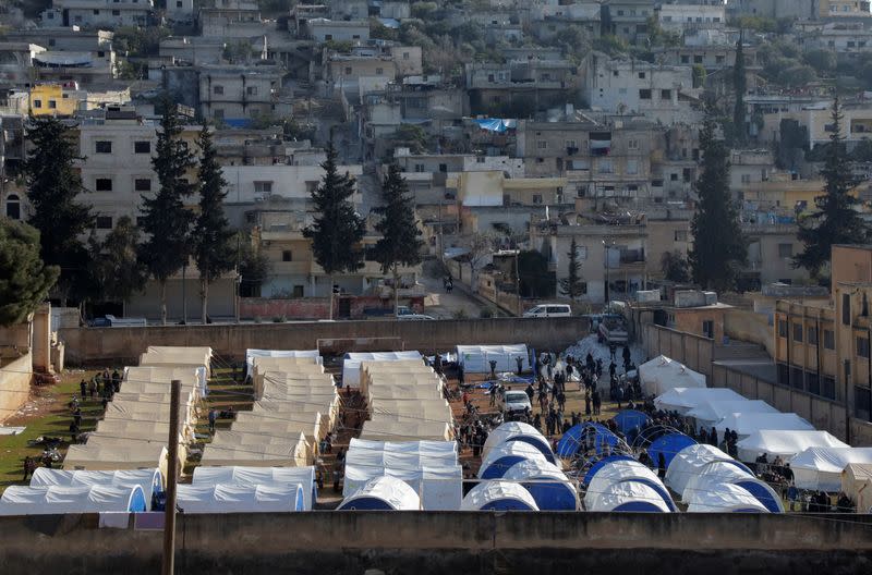 Displaced Syrians set up tents in a school yard in Harem