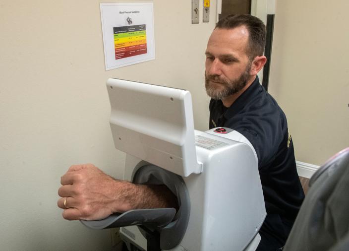 Stockton police chaplain Dan Deuel tries out a blood pressure machine at the Stockton Police Department's organizational wellness unit in downtown Stockton on Wednesday, Feb. 22, 2023.