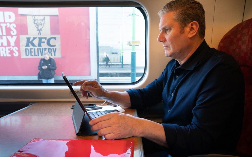 Sir Keir Starmer, the Labour leader, is pictured travelling to Birmingham today - Stefan Rousseau/PA