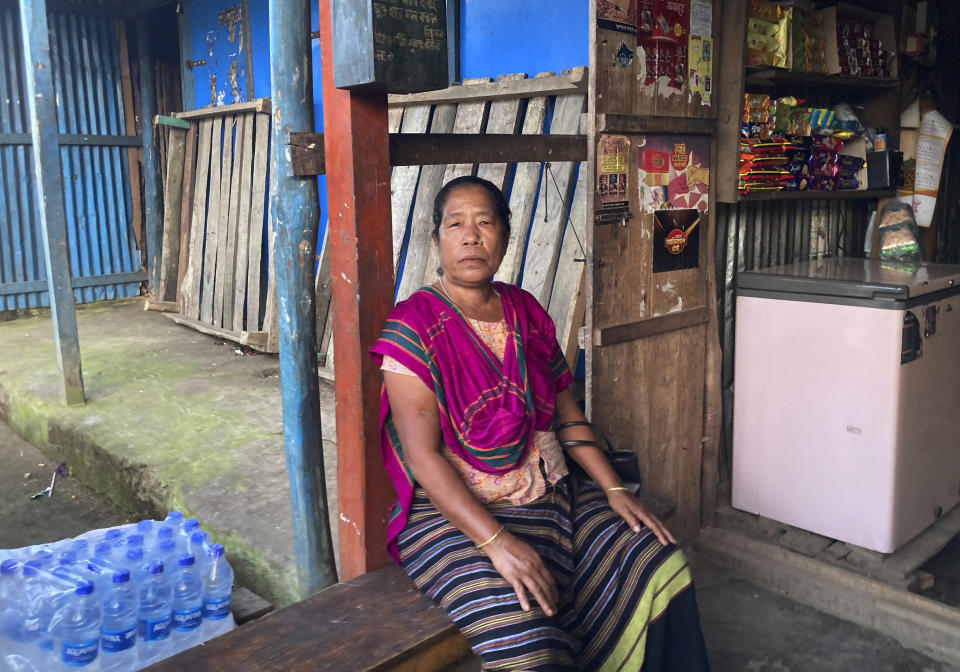 Tribal woman Modhumala Chakma, sits in front of a shop in Rangamati district of Bangladesh, Sunday, Nov. 27, 2022. Bangladesh is marking 25 years since it signed a peace treaty to end an armed insurgency in southeastern Bangladesh. (AP Photo/Al-emrun Garjon)