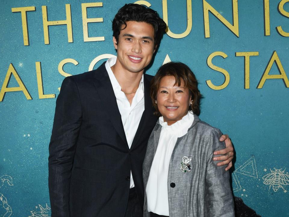 charles melton with his arm around his mother on the red carpet, both smiling