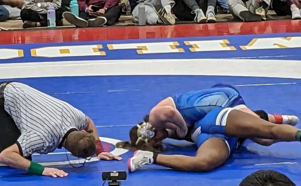 Ashland's Nora Quitt, top, is about to pin Kan-yah McCarthy of Fairfield Ludlowe, Connecticut, in the finals of the 138-pounds weight class at the New England championships in Providence on Saturday, March 2, 2024.