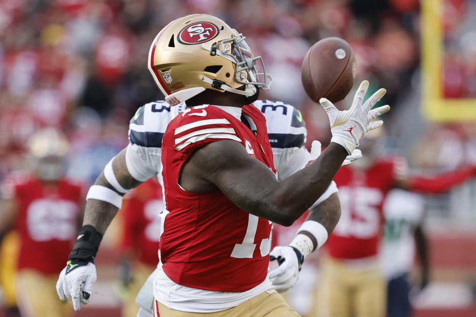 San Francisco 49ers wide receiver Deebo Samuel catches a touchdown pass in front of Seattle Seahawks safety Jamal Adams during the first half of an NFL football game in Santa Clara, Calif., Sunday, Dec. 10, 2023. (AP Photo/Josie Lepe)