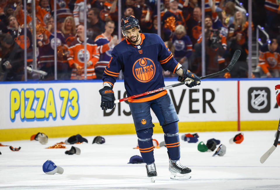 Edmonton Oilers winger Evander Kane skates amongst hats thrown onto the ice after his hat-trick during the second period of an NHL hockey Stanley Cup second-round playoff series game in Edmonton, Alberta, Sunday, May 22, 2022. (Jeff McIntosh/The Canadian Press via AP)