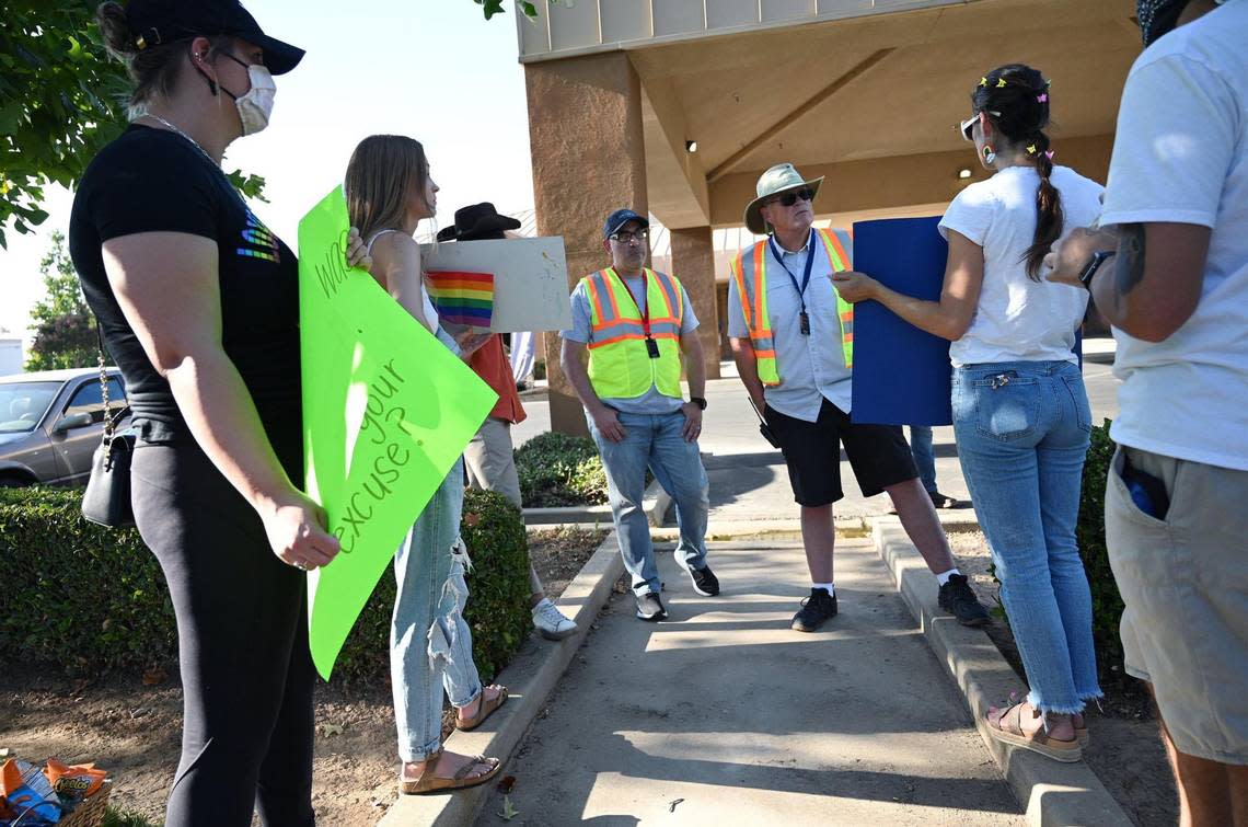 Church staff, center, engage with protesters outside The Well Community Church-North Campus over promotion of the sermon A Biblical View of Sexuality outside which protesters said is anti-gay Thursday, Aug. 18, 2022.