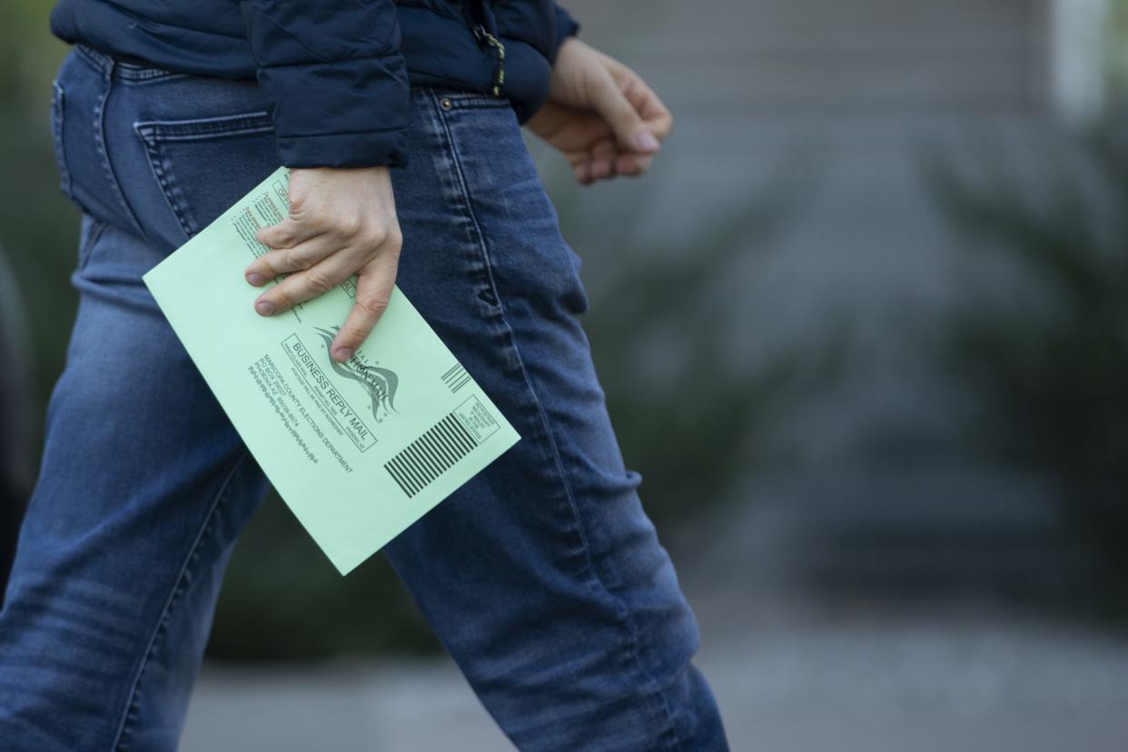 People arrive to cast their early vote in the 2020 election at an early ballot location at the Burton Barr Central Library in Phoenix, Ariz., on Oct. 28, 2020.