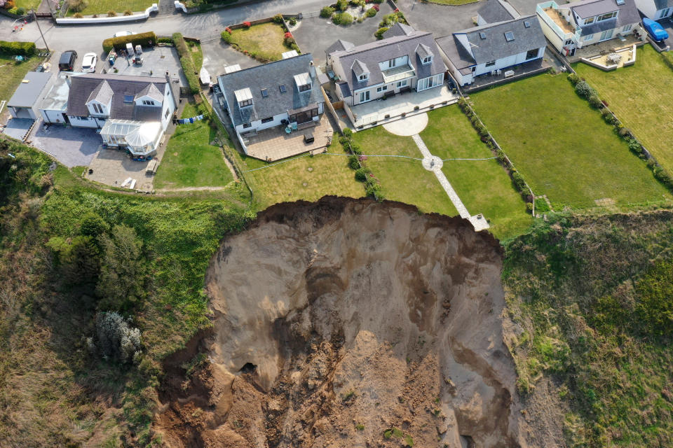 NEFYN, WALES - APRIL 21: Houses are seen next to the cliff edge after a landslide at Nefyn Beach in Gwynedd, North Wales on April 21, 2021 in Nefyn, United Kingdom. Following the large land slip people were advised to temporarily relocate. (Photo by Christopher Furlong/Getty Images)