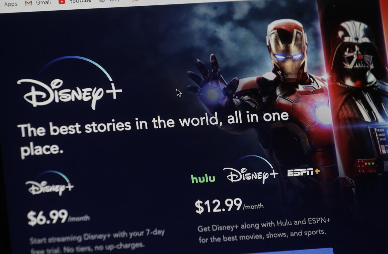 An introductory page on the Disney Plus website is displayed on a computer screen in Walpole, Mass., Wednesday, Nov. 13, 2019. Disney Plus says it hit more than 10 million sign-ups on its first day of launch, far exceeding expectations. (AP Photo/Steven Senne)