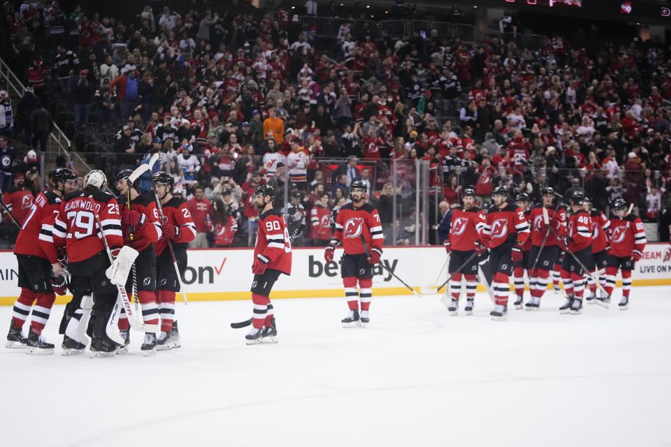 New Jersey Devils goaltender Mackenzie Blackwood (29) celebrates with teammates after the their 4-2 win in an NHL hockey game against the Winnipeg Jets on Sunday, Feb. 19, 2023, in Newark, N.J. (AP Photo/Frank Franklin II)