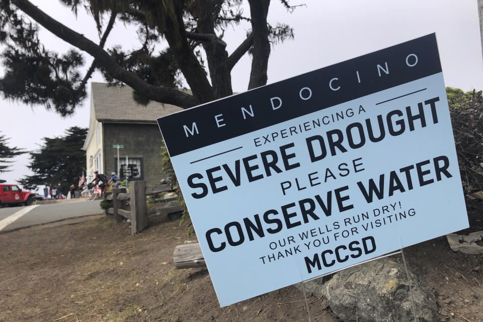 FILE— Signs alert visitors to the severe drought in Mendocino, Calif., on Wednesday, Aug. 4, 2021. California Gov. Gavin Newsom threatened Monday, May 23, 2022, to impose mandatory, statewide restrictions on water use if people don't start using less on their own as the drought drags on and the hotter summer months approach. (AP Photo/Haven Daley, File)