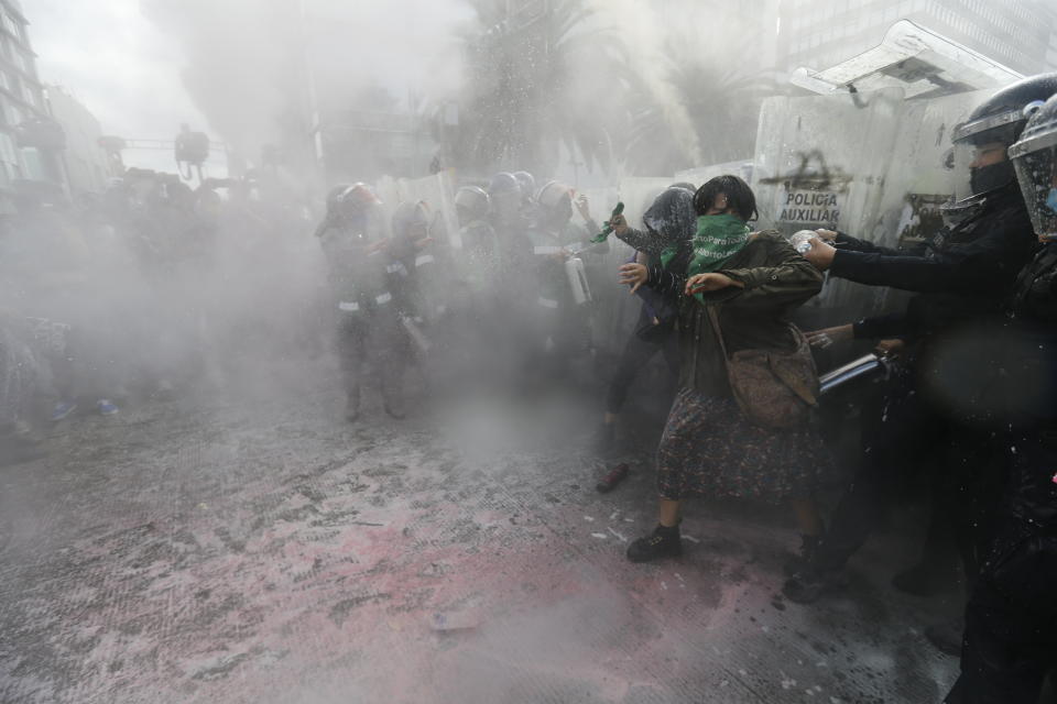 Demonstrators clash with riot police during a march supporting abortion rights in Mexico City, Monday, Sept. 28, 2020. (AP Photo/Marco Ugarte)