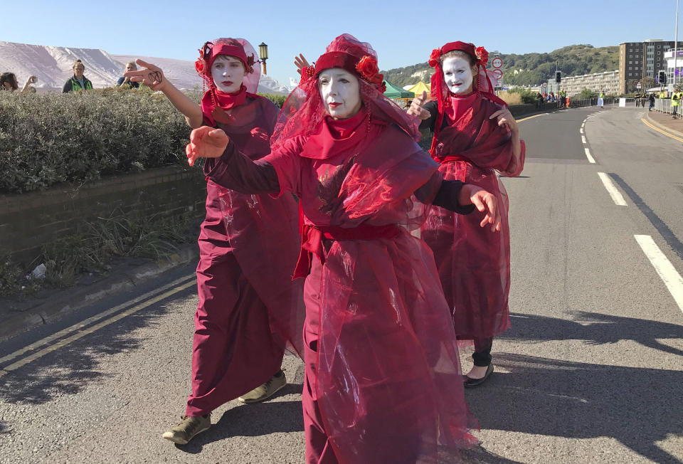 Members of Extinction Rebellion climate protester group occupy one side of a dual carriageway at the Port of Dover, Dover, England. Saturday Sept. 21, 2019. Two lanes at the busy Kent port have been fenced off and taken over by the environmental activists amid a heavy police presence. (Michael Drummond/PA via AP)(/PA via AP)