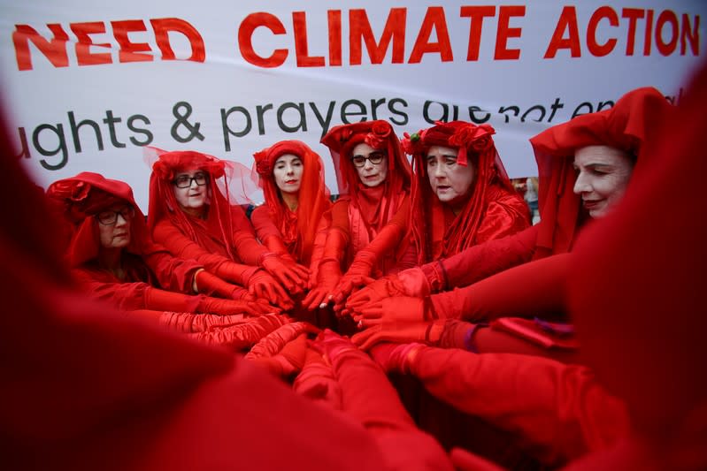 Red Rebels from Extinction Rebellion are seen during a School Strike for Climate Australia (SS4C) 'Solidarity Sit-down' outside of the office of the Liberal Party of Australia in Sydney