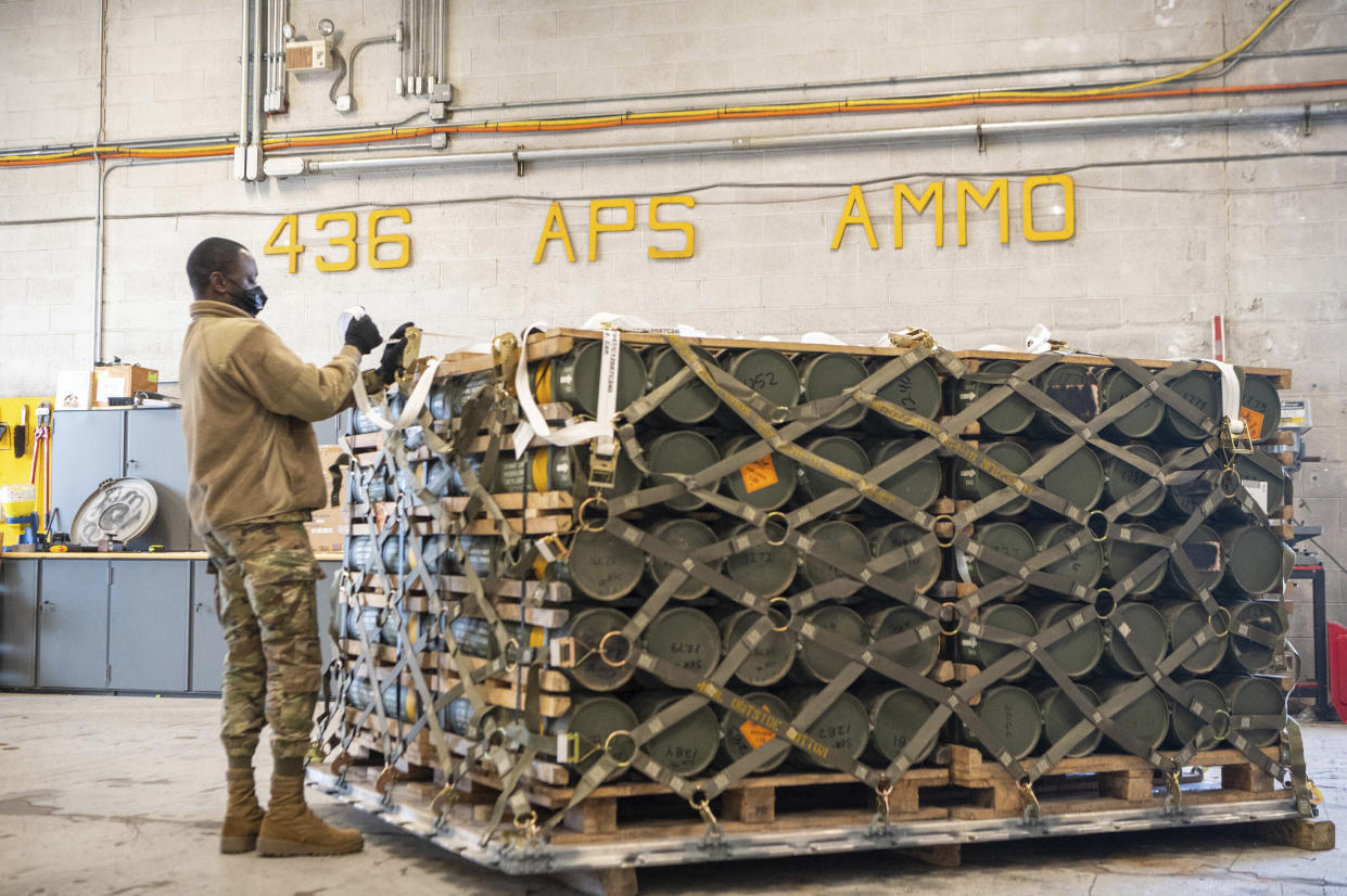 In this image provided by the U.S. Air Force, Airmen and civilians from the 436th Aerial Port Squadron palletize ammunition, weapons and other equipment bound for Ukraine during a foreign military sales mission at Dover Air Force Base, Del.